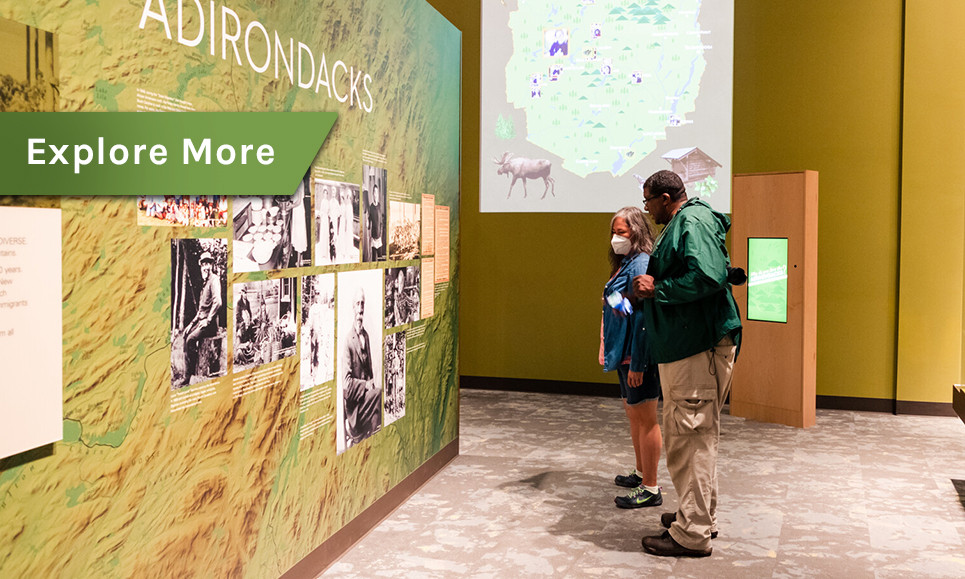 A couple reads a display with historic photos at a museum.